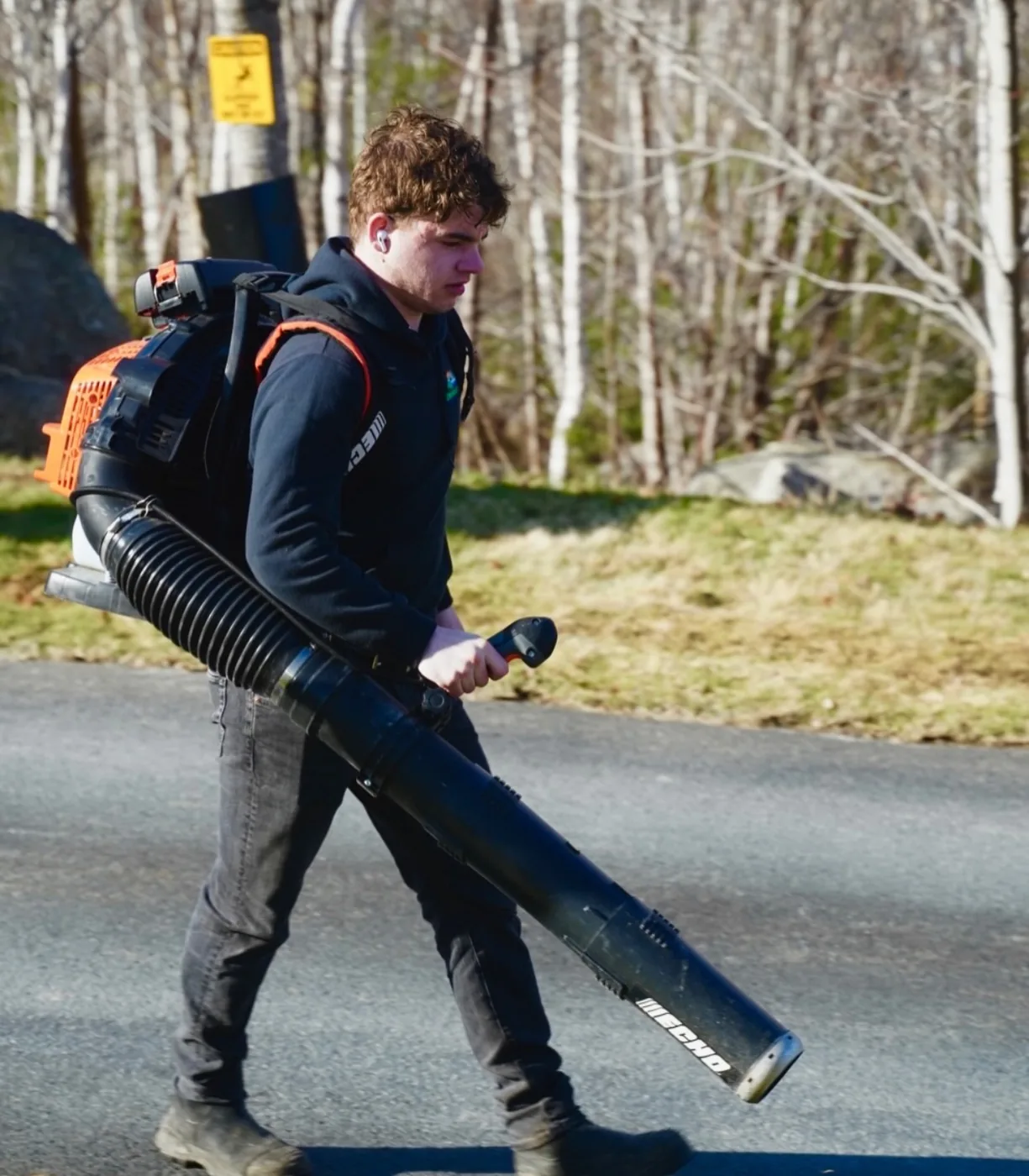 Connor Amero, owner of Dunbrack’s Outdoor Services in Halifax, Nova Scotia, carrying a backpack leaf blower on the job