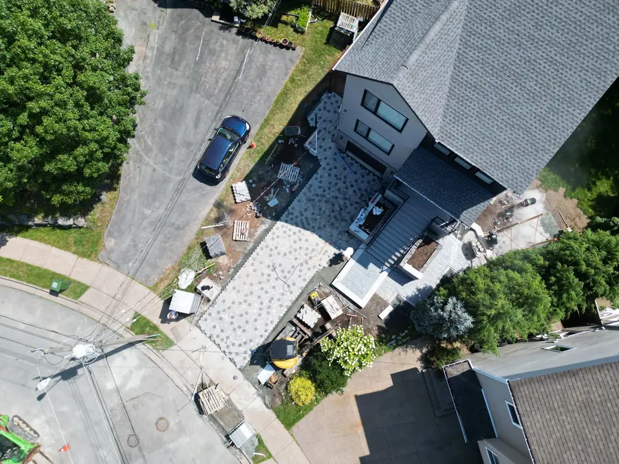 Aerial view of a paver driveway and walkway installation at a corner-lot home — hardscaping project in Halifax, Nova Scotia