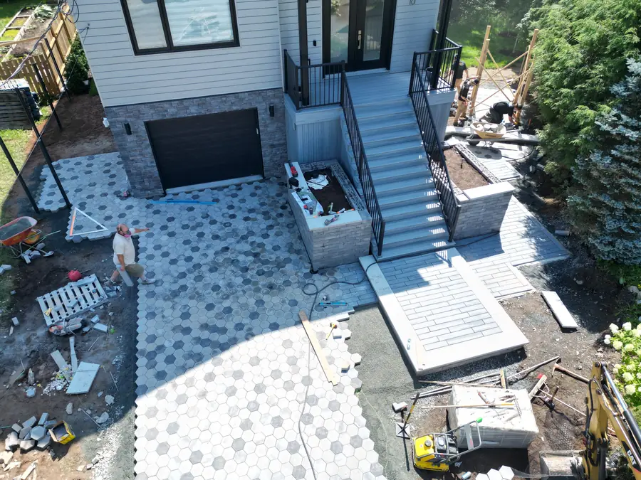 Aerial view of a hexagon paver driveway and entrance steps being installed at a new home — hardscaping project in Halifax, Nova Scotia